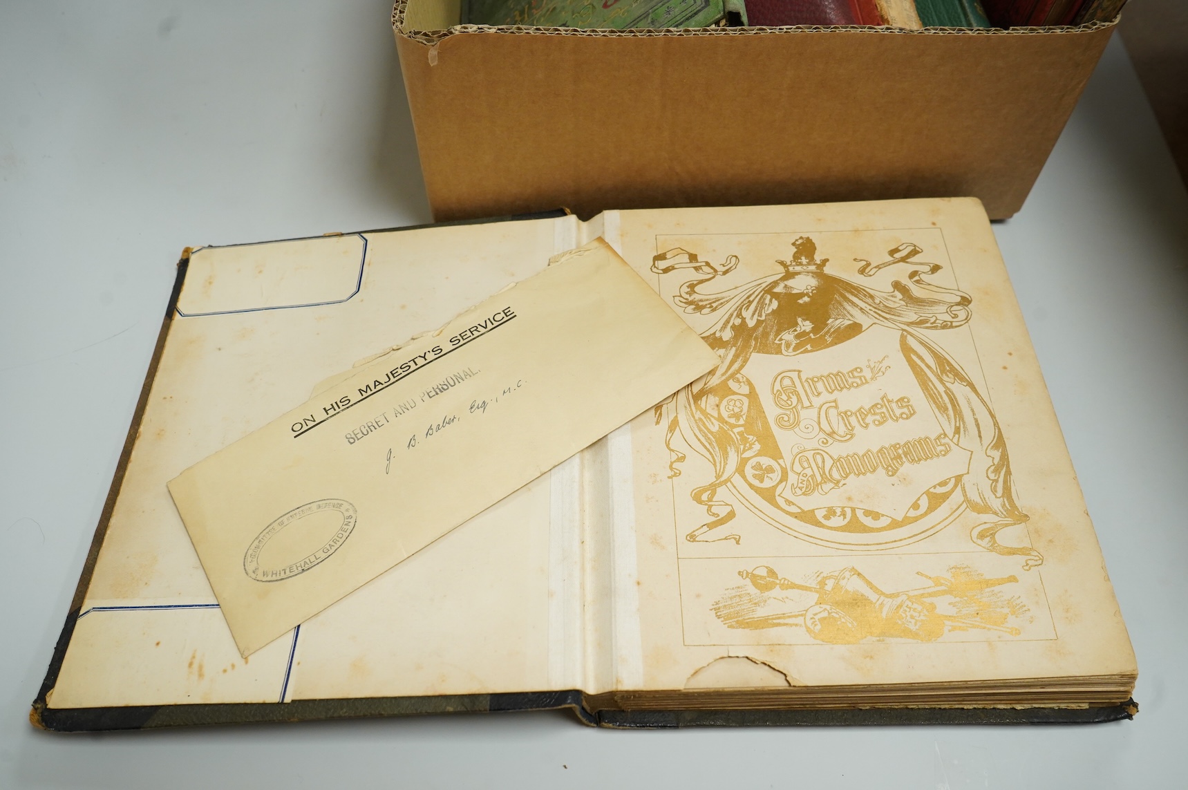 A collection of Victorian and later crest and monogram albums and loose crests and monograms